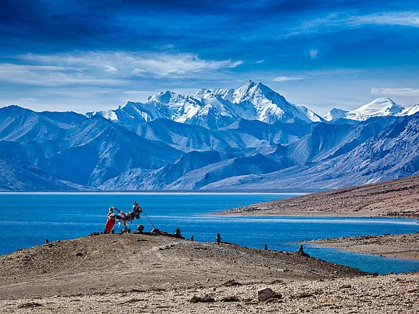 Crystal clear, color-changing blue waters of Pangong Lake: The Blue That Defies Reality surrounded by barren Himalayan mountains in Ladakh.